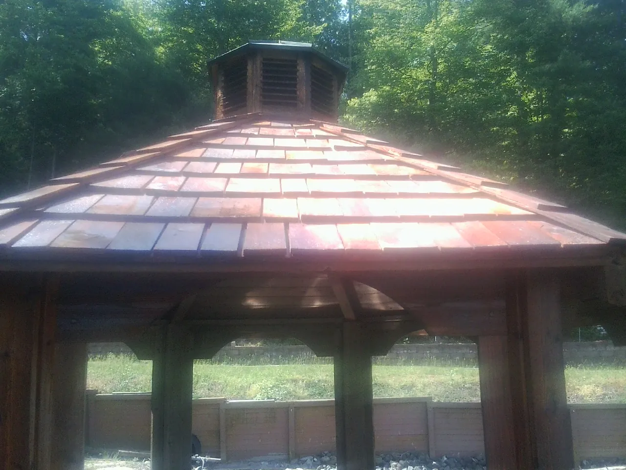 New cedar shake roof and cupola on a lakeside gazebo in Worthington