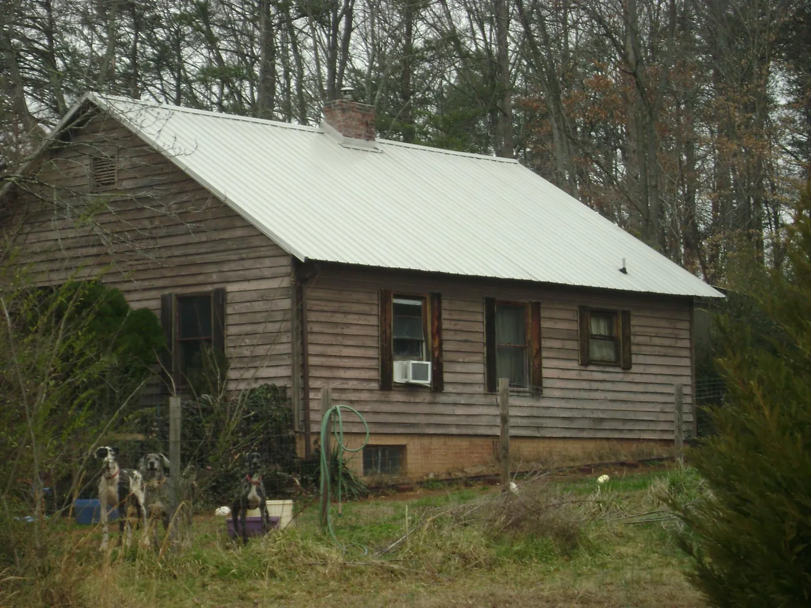 White metal roof on an old wood sided farmhouse, from a Metal Roof Installation job in Worthington